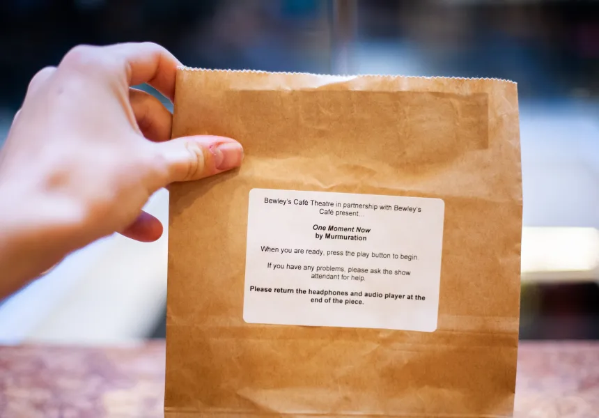 paper bag with instructions for participating in One Moment Now Murmuration show