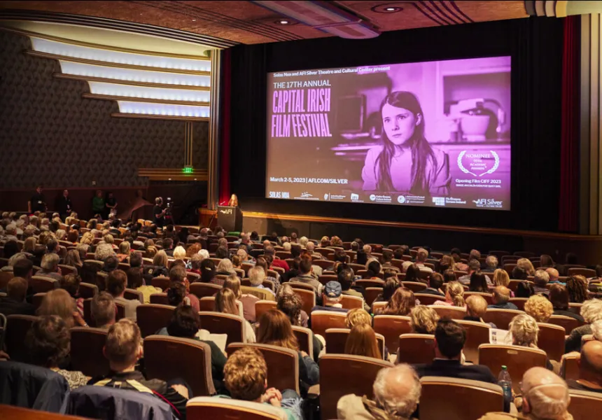 Theater full of people facing away, looking at screen announcing CIFF 2023