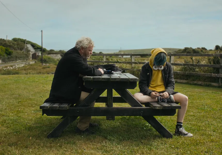 WEST OF THE HORIZON image, young boy and old man sit at picnic table