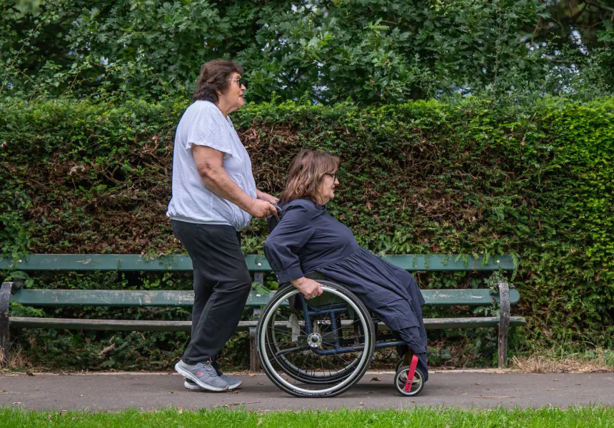 AFTER THE BOMB image, two women, one being pushed in wheelchair