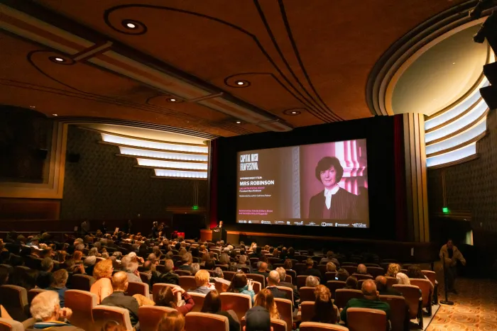 angled photo of the full theatre with a photo of Mary Robinson onscreen CIFF2025